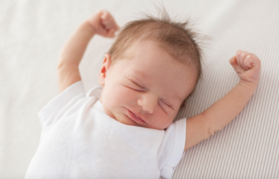 Infant lying on bed