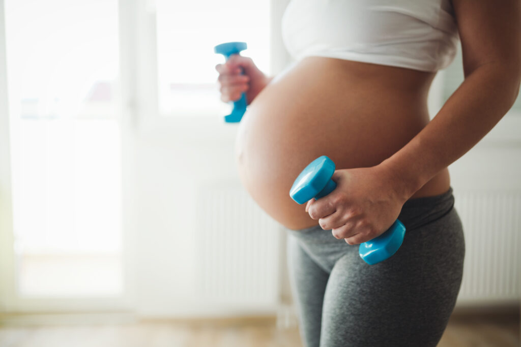 Healthy pregnant woman practicing fitness and exercising during pregnancy